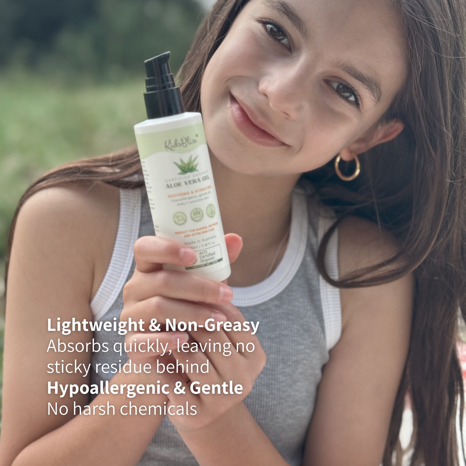 Girl holding ACO Certified Organic Aloe Vera Gel 100ml for soothing and hydrating skin care.